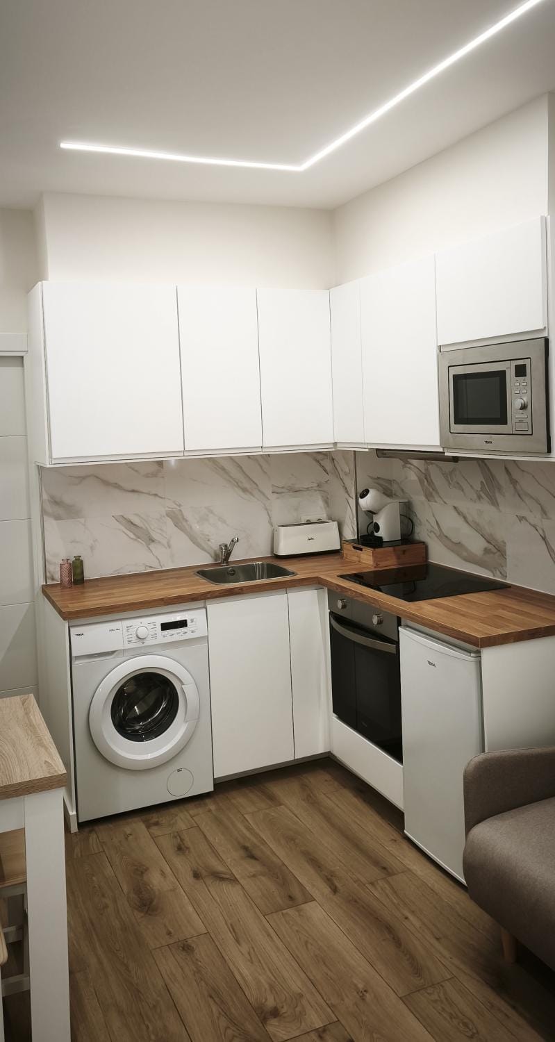 Kitchen or kitchenette, oven, stove, toaster, washing machine