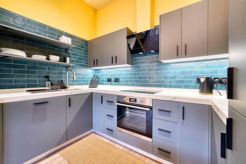 Kitchen or kitchenette, dishwasher, oven, stove