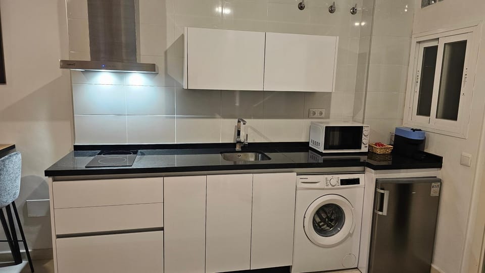 Kitchen or kitchenette, stove, toaster, washing machine