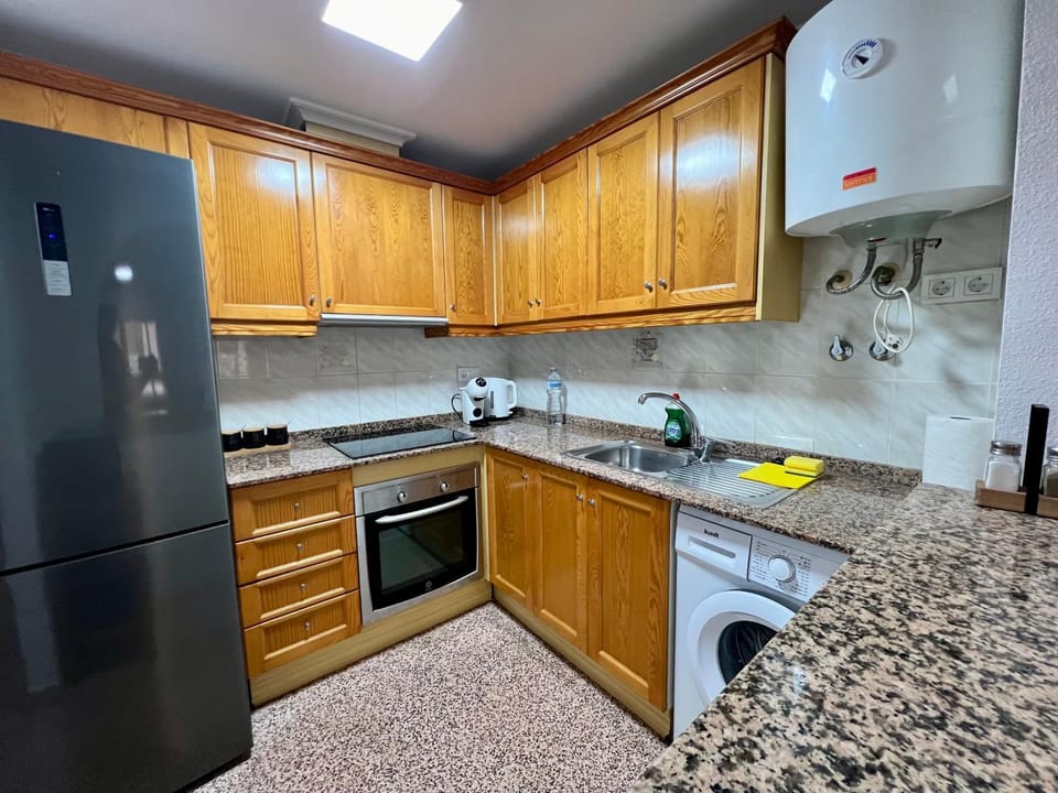 Kitchen or kitchenette, oven, stove, washing machine