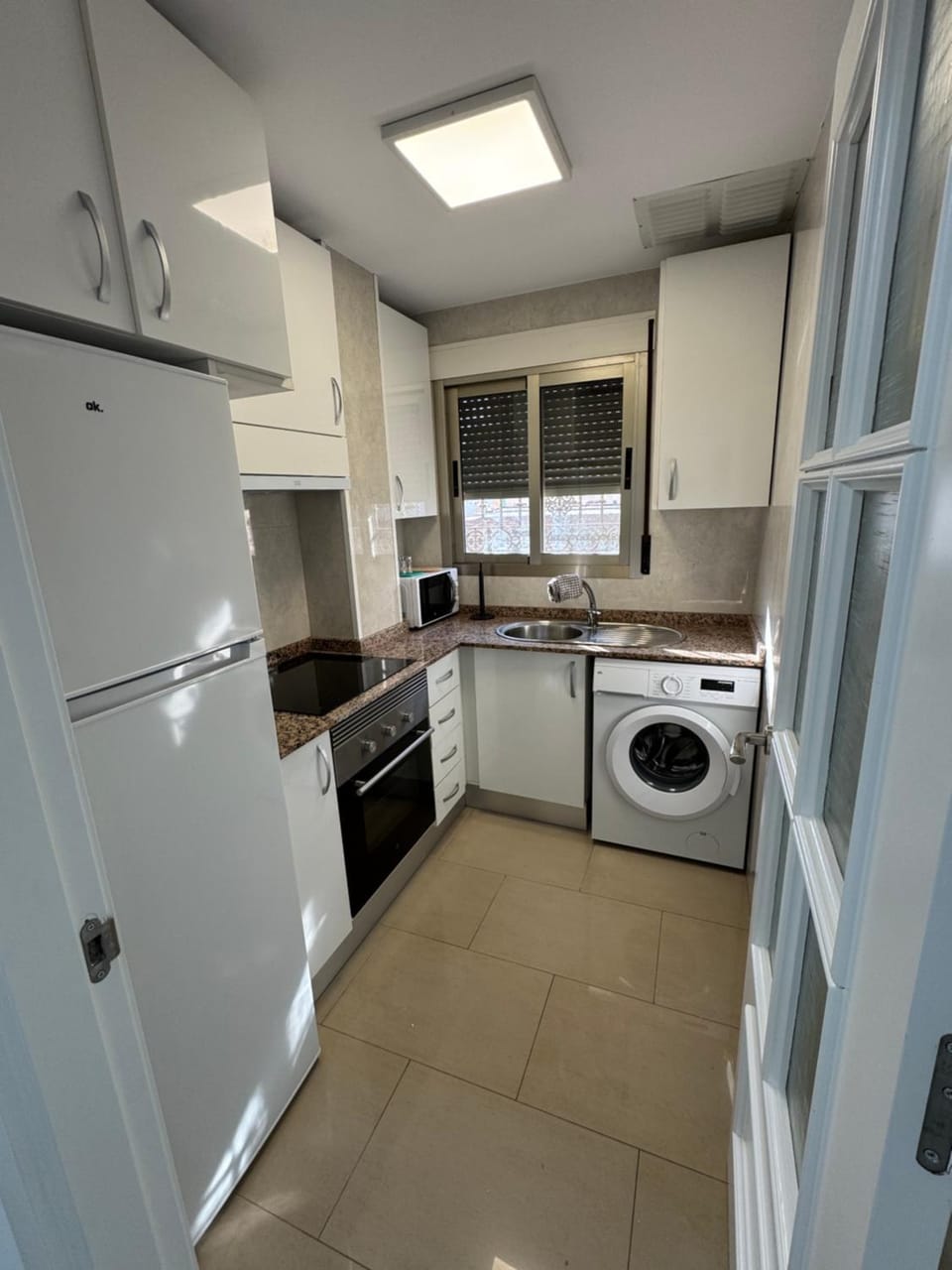 Kitchen or kitchenette, oven, stove, washing machine