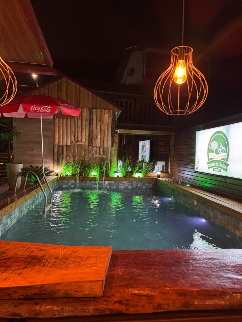 Communal lounge/ TV room, Night, Pool view, Swimming pool