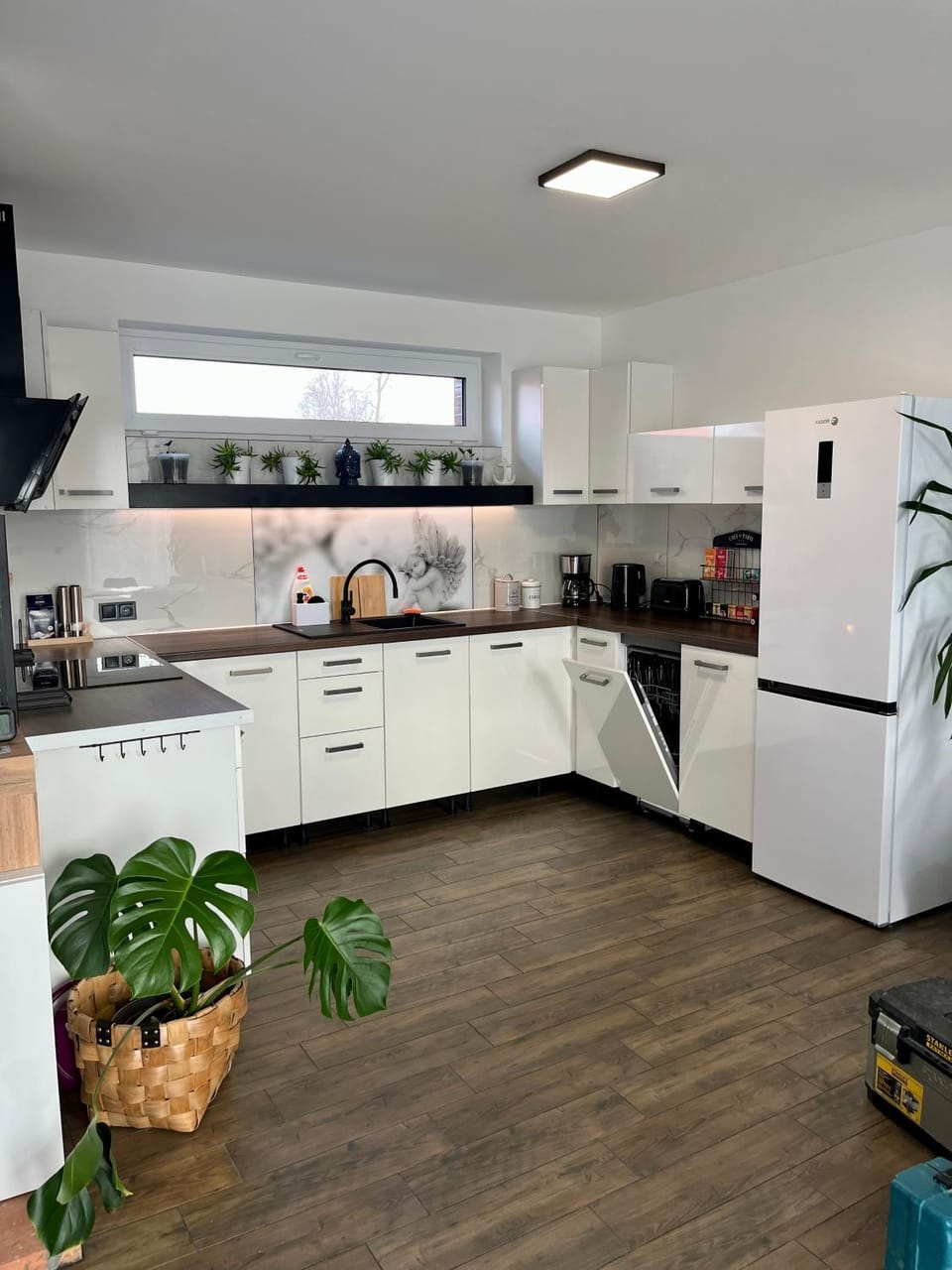 Kitchen or kitchenette, dishwasher, oven, stove