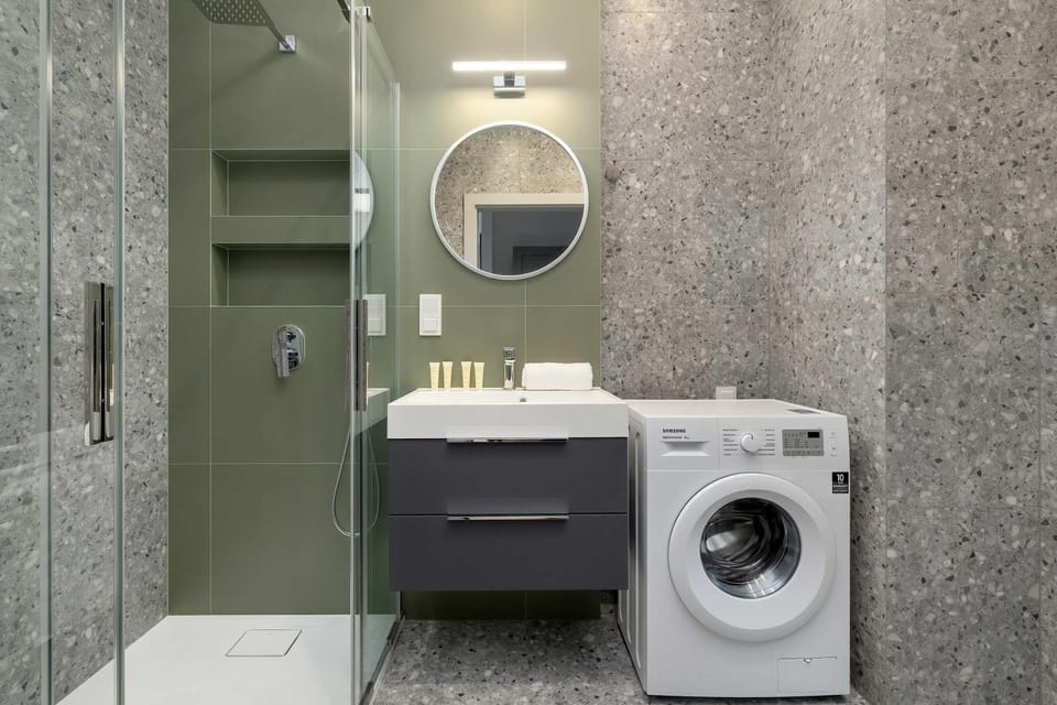 Shower, Bathroom, hair dryier, towels, washing machine