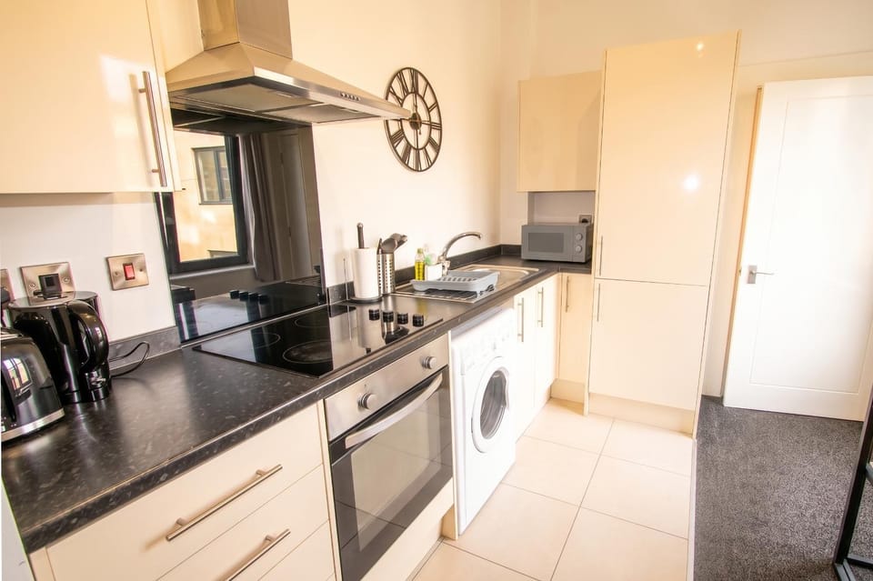 Kitchen or kitchenette, microwave, oven, stove, washing machine