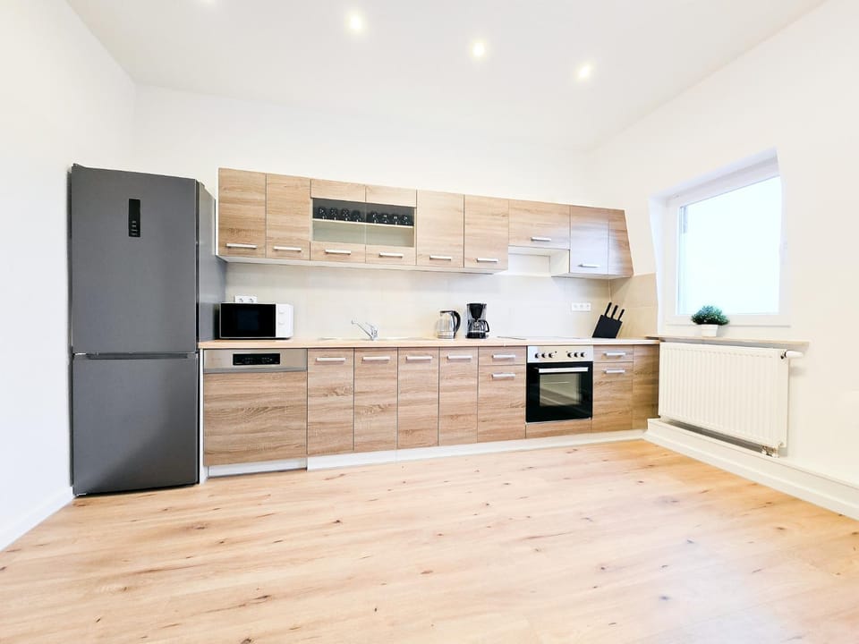 Kitchen or kitchenette, dishwasher, oven, stove