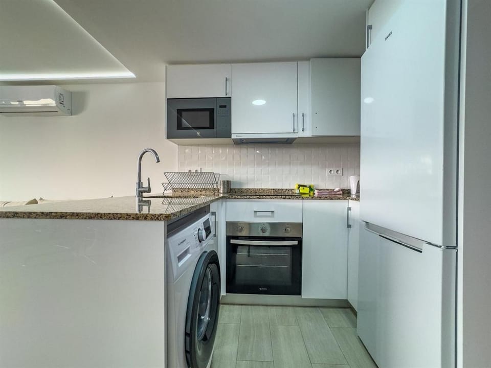 Kitchen or kitchenette, oven, stove, washing machine