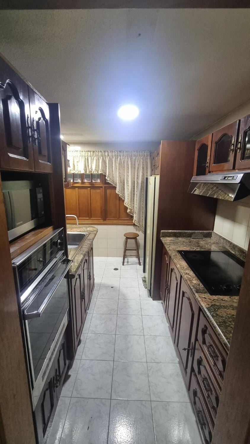 Kitchen or kitchenette, dishwasher, microwave, oven, stove
