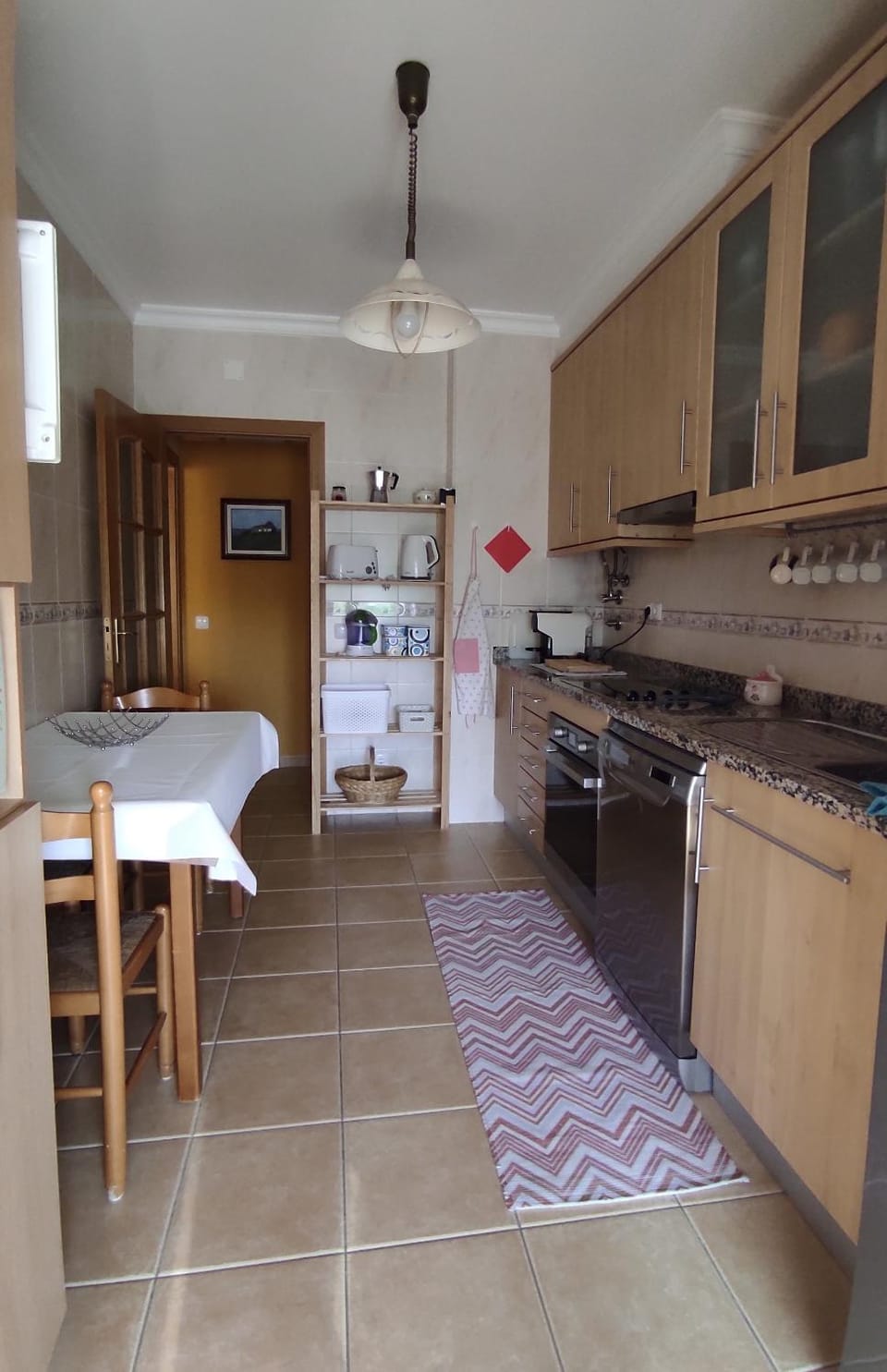 Kitchen or kitchenette, dishwasher, oven, stove