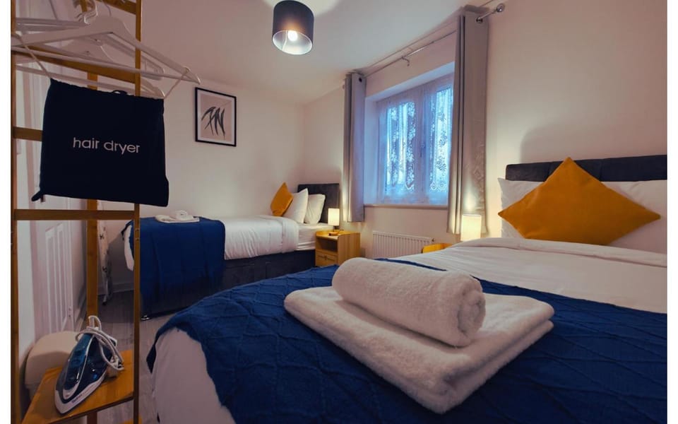 Bed, Photo of the whole room, Bedroom, flat iron, hair dryier, towels