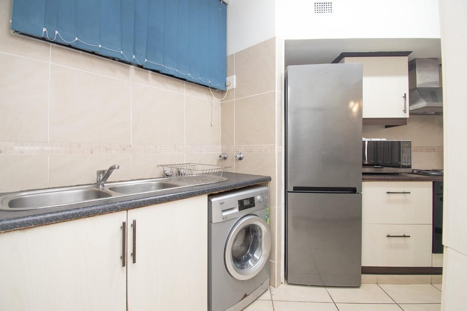 Kitchen or kitchenette, oven, stove, washing machine