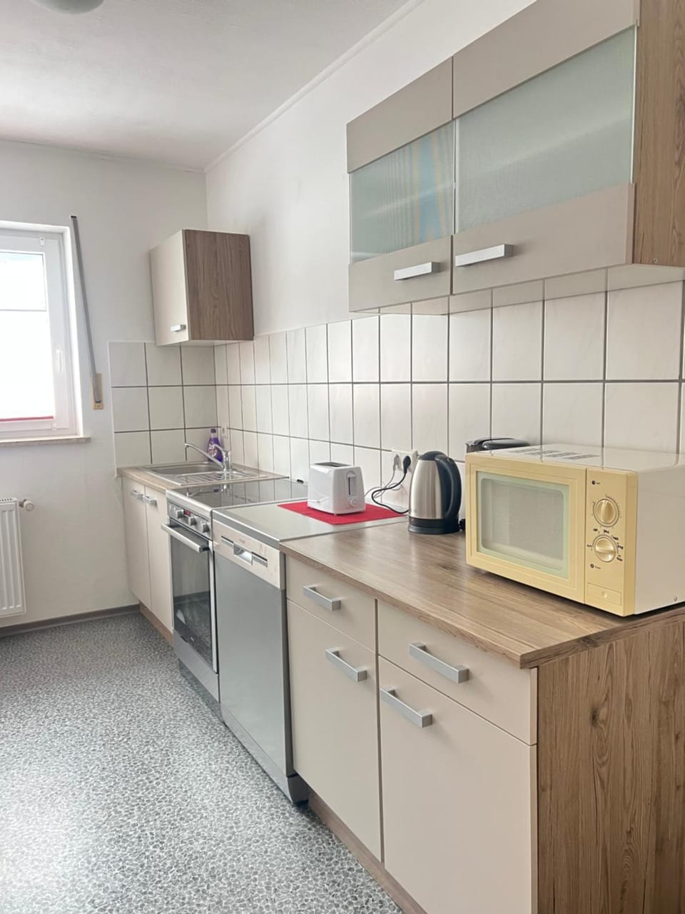 Kitchen or kitchenette, dishwasher, stove, toaster