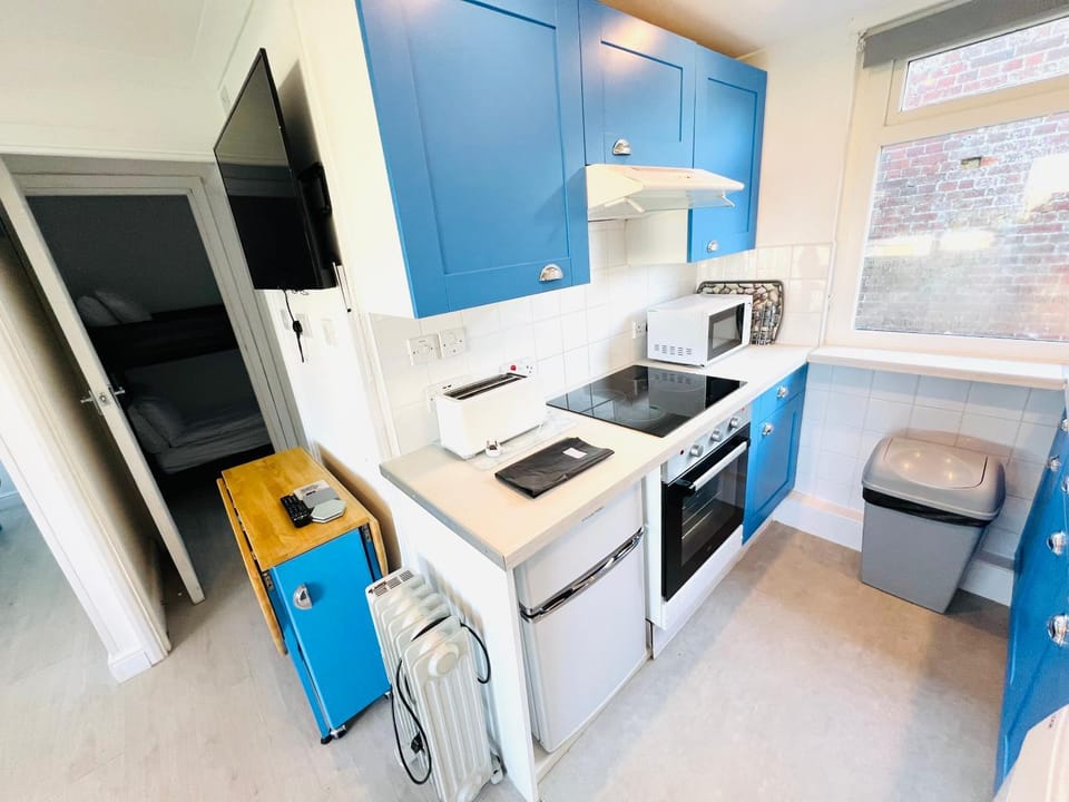 Kitchen or kitchenette, microwave, oven, stove, toaster