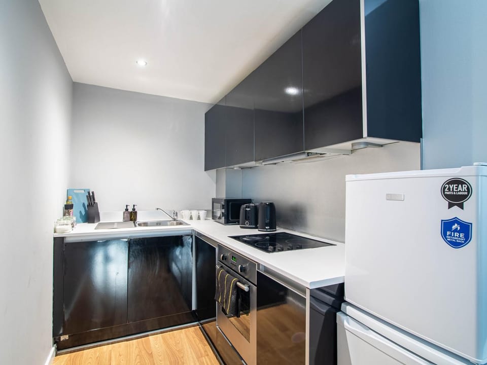 Kitchen or kitchenette, oven, stove, toaster, washing machine