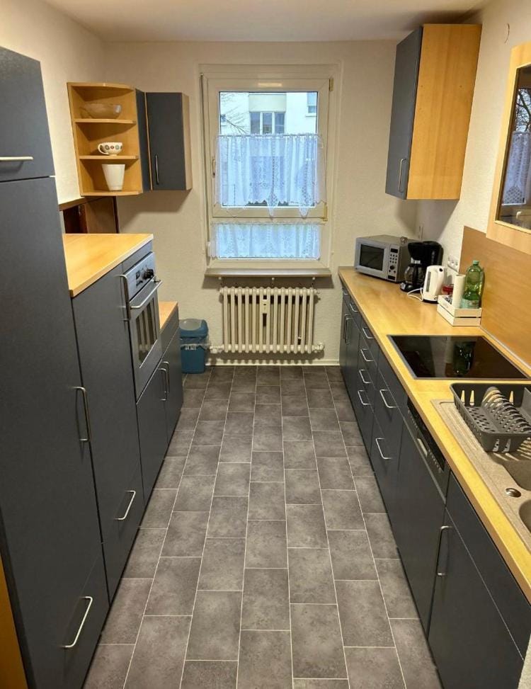 Kitchen or kitchenette, dishwasher, oven, stove
