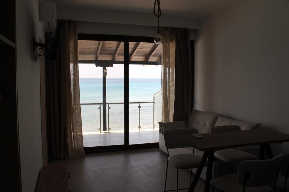 View (from property/room), Living room, Seating area, Dining area, Sea view