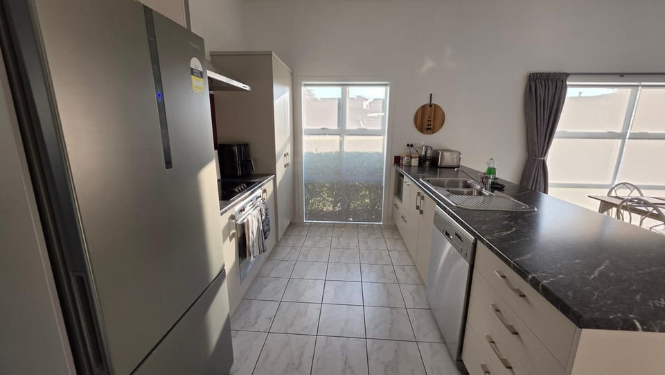 Kitchen or kitchenette, dishwasher, oven, stove