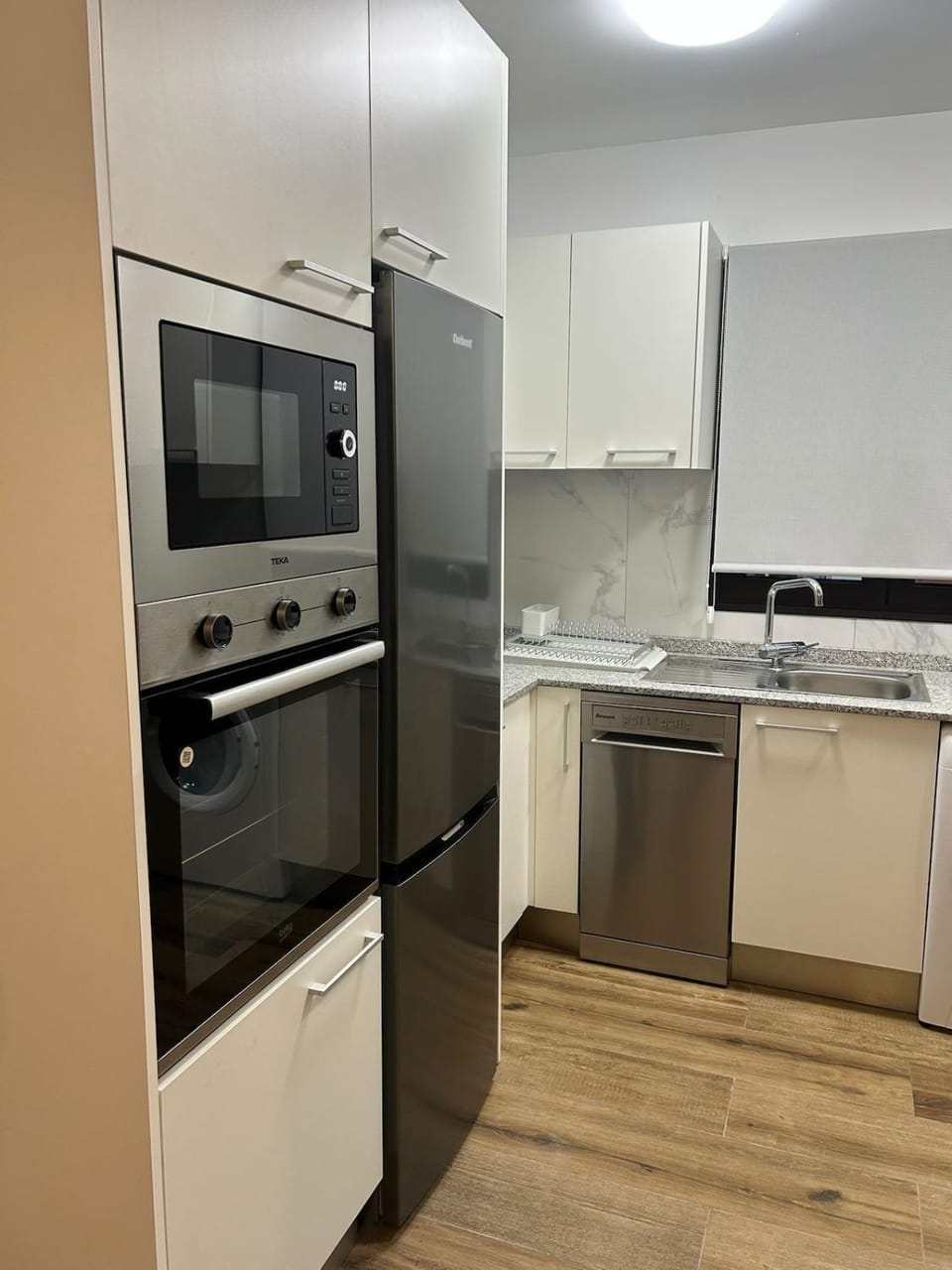 Kitchen or kitchenette, dishwasher, oven, stove