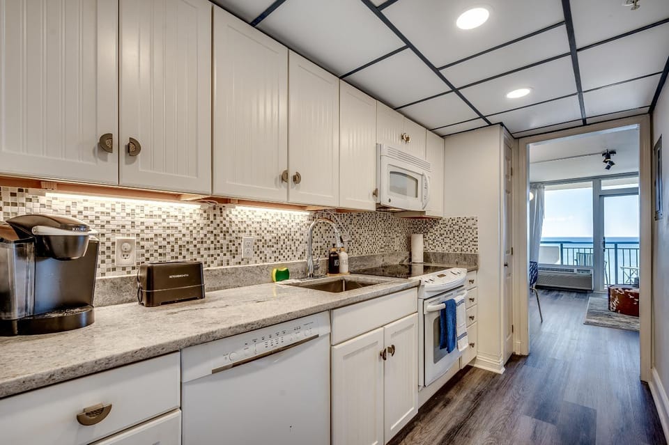 Kitchen or kitchenette, dishwasher, oven, stove, toaster