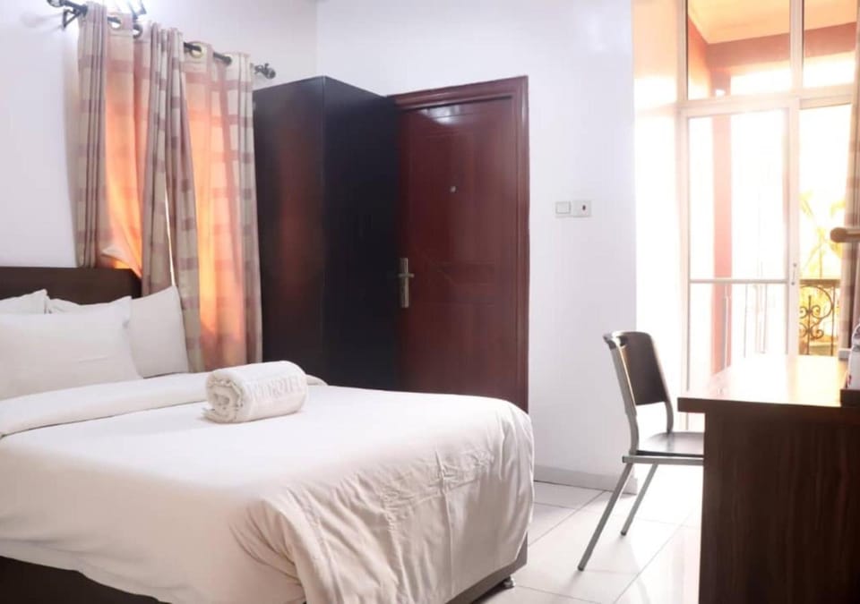 Bed, Seating area, towels, wardrobe