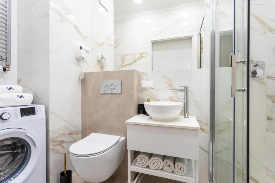 Shower, Toilet, Bathroom, bidet, towels, washing machine, dryer