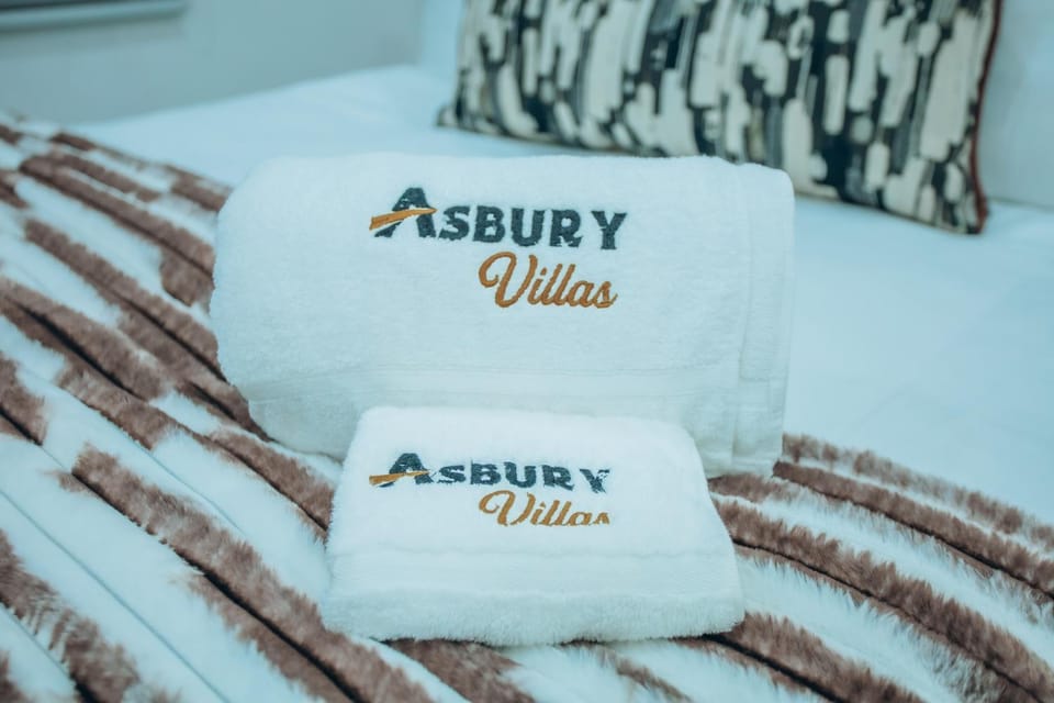 Bed, Property logo or sign, towels