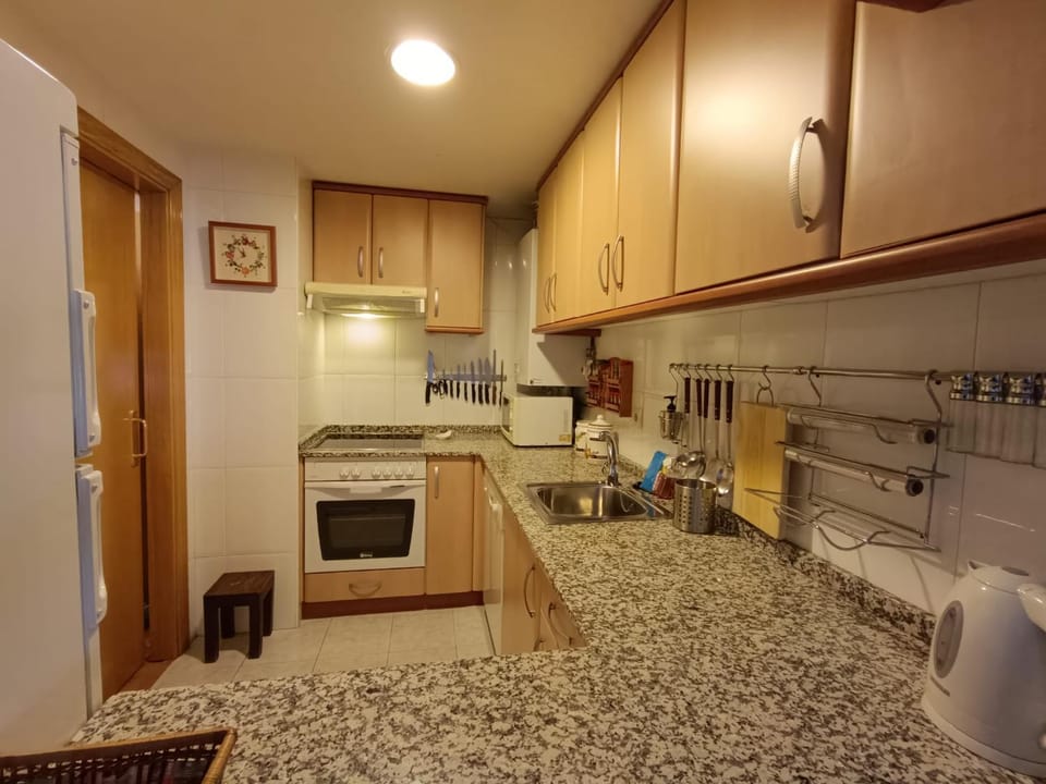 Kitchen or kitchenette, dishwasher, oven, stove