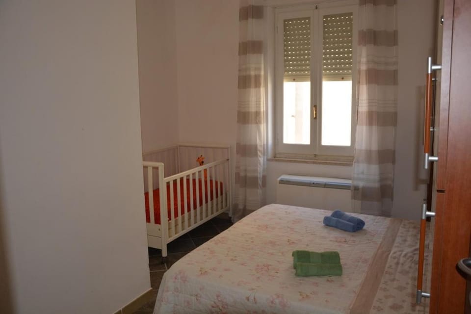 Bedroom, cot, towels, air conditioner