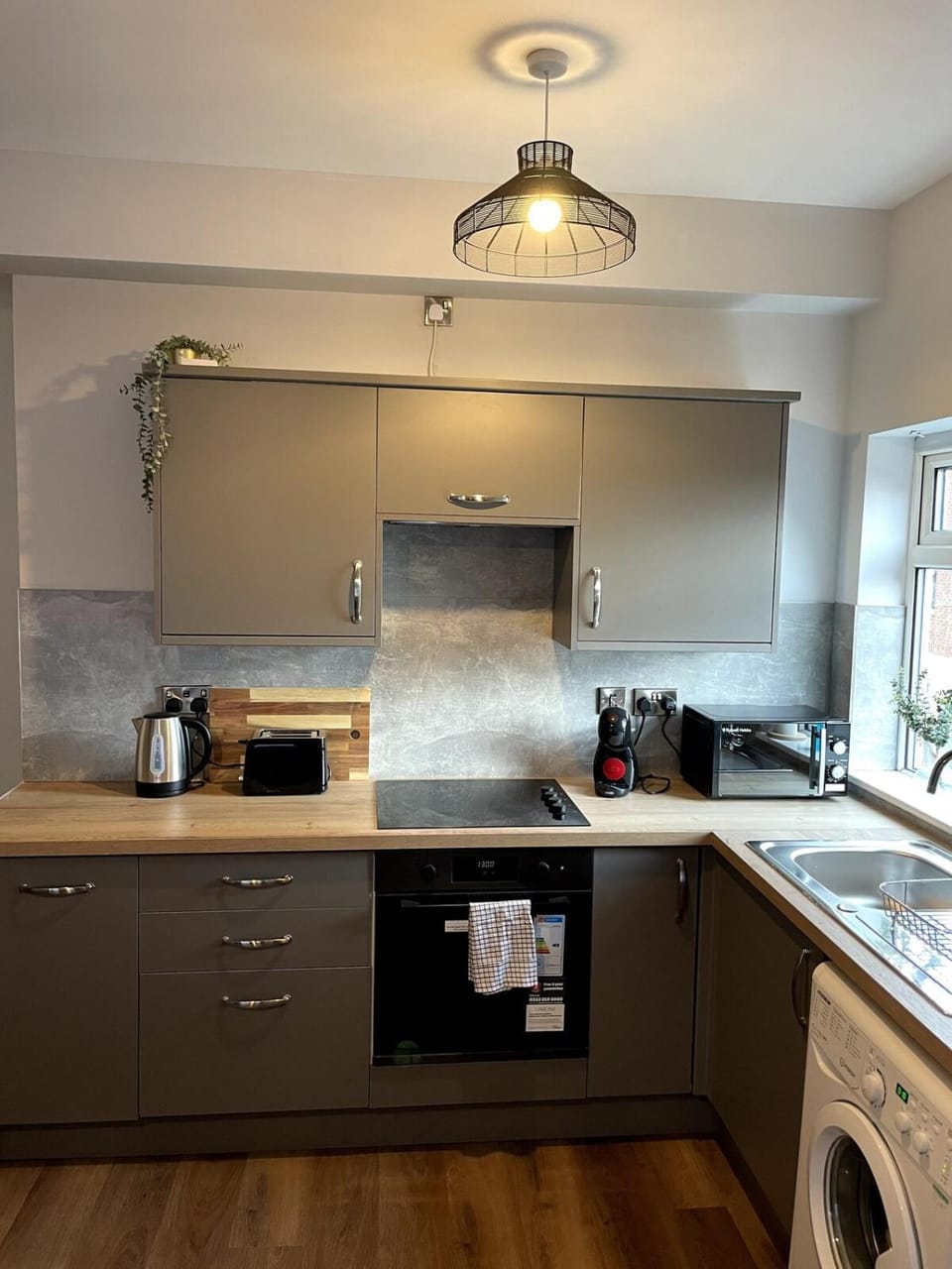Kitchen or kitchenette, oven, stove, toaster, washing machine