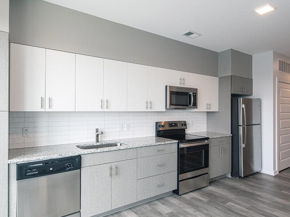 Kitchen or kitchenette, dishwasher, oven, stove
