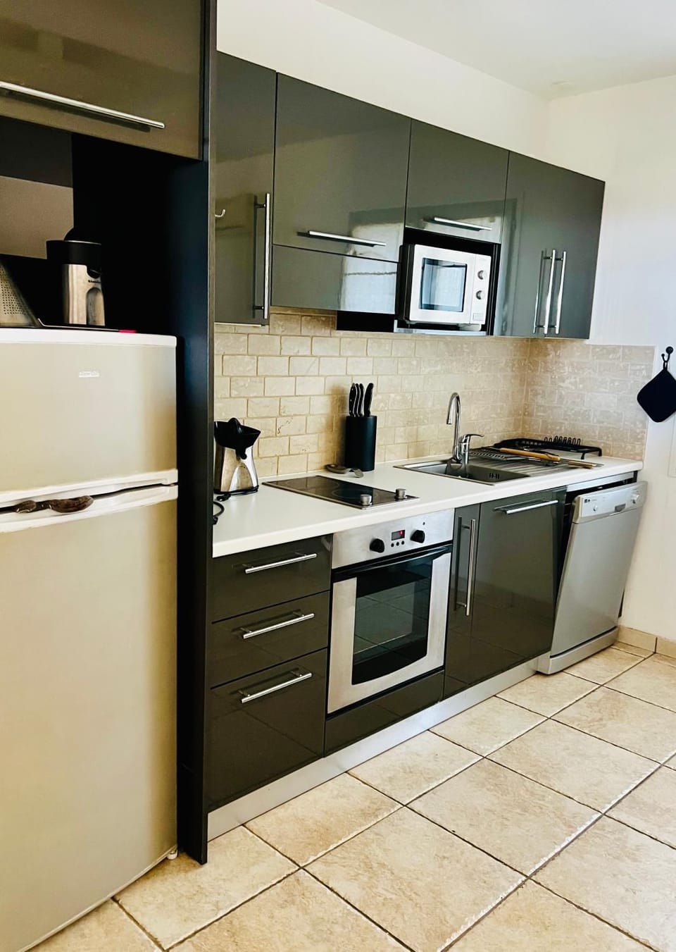 Kitchen or kitchenette, dishwasher, oven, stove