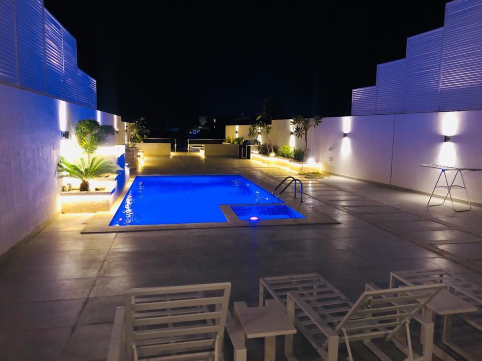 Patio, Night, Pool view, Swimming pool, sunbed