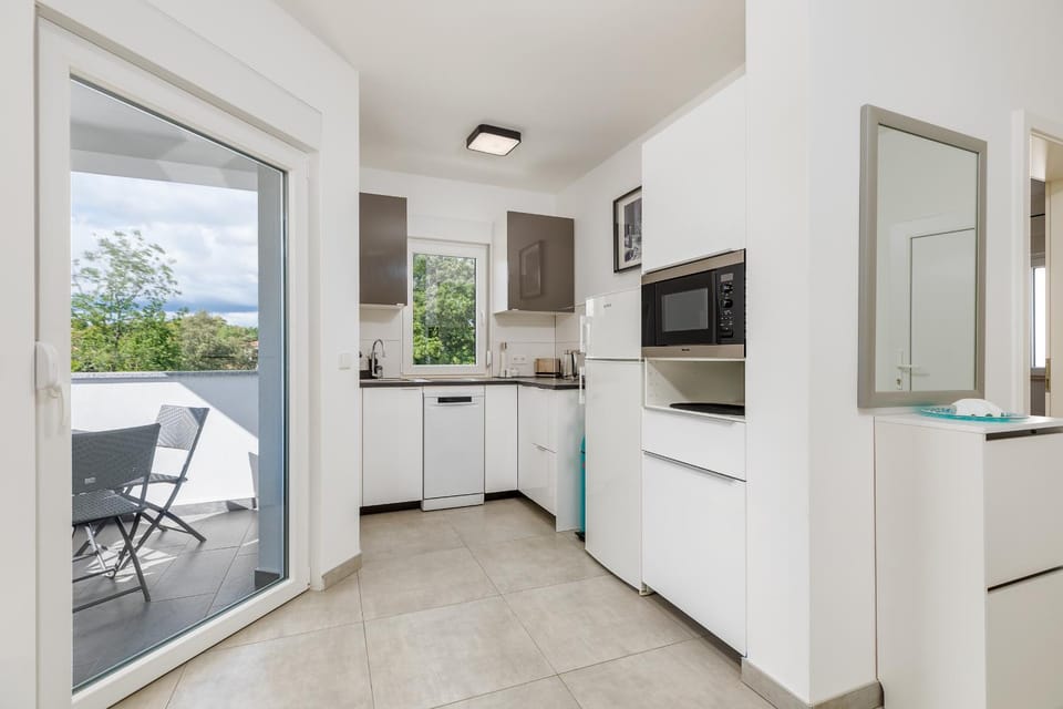 Kitchen or kitchenette, dishwasher, microwave, stove, toaster