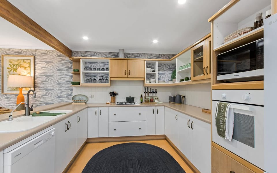 Kitchen or kitchenette, dishwasher, oven, stove