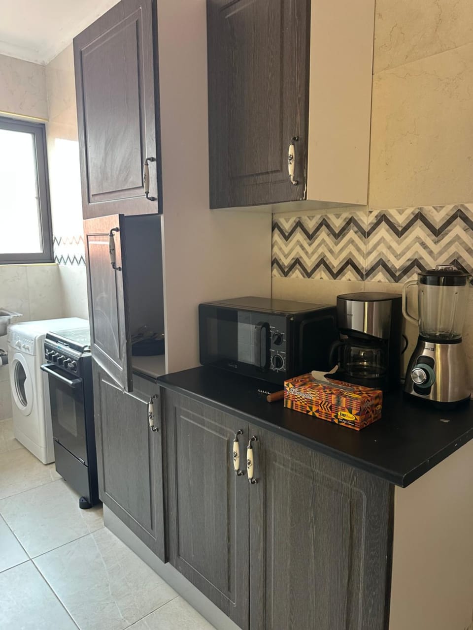 Kitchen or kitchenette, microwave, oven, washing machine