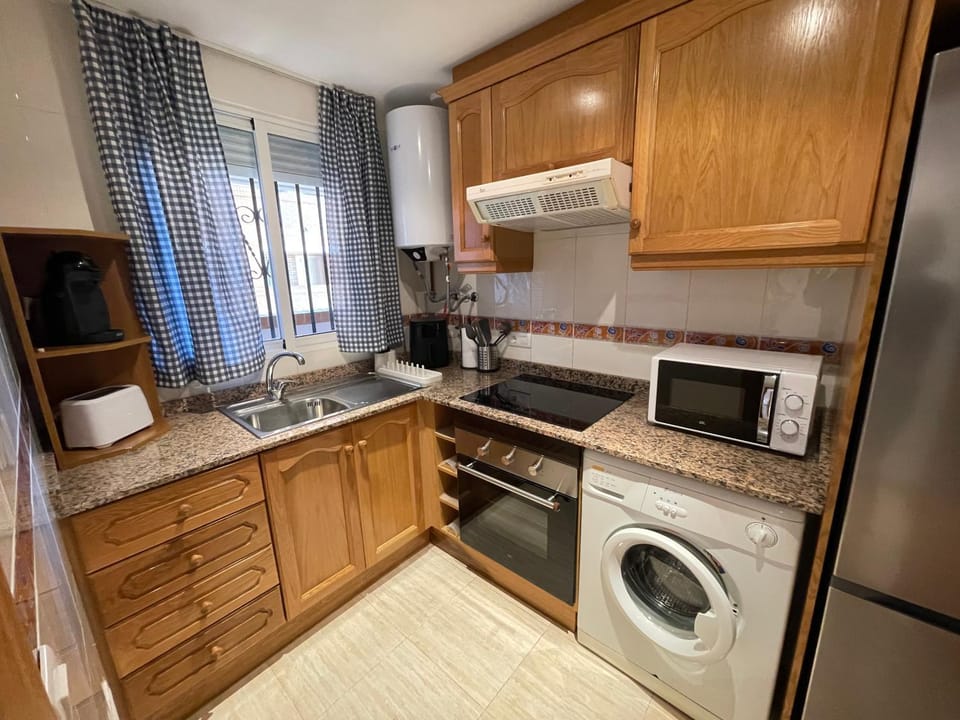 Kitchen or kitchenette, oven, stove, toaster, washing machine