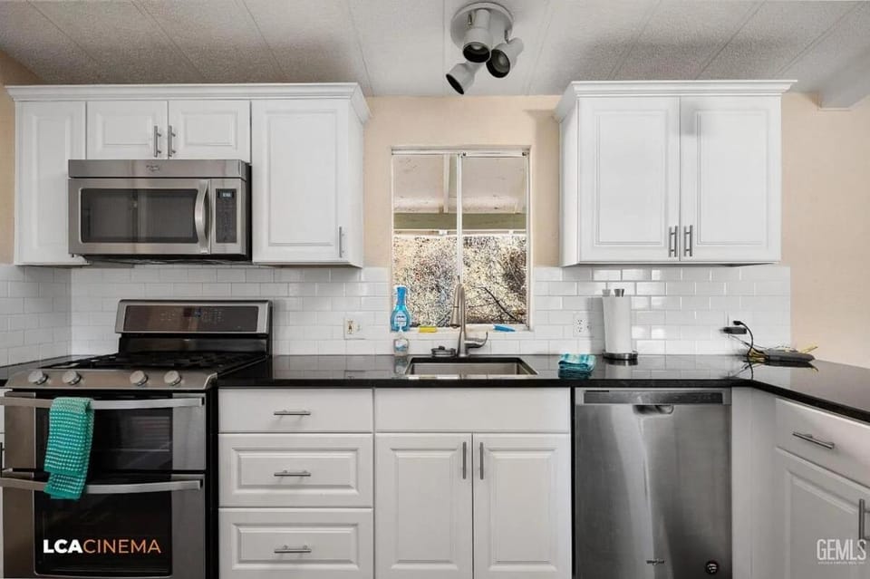 Kitchen or kitchenette, dishwasher, oven, stove