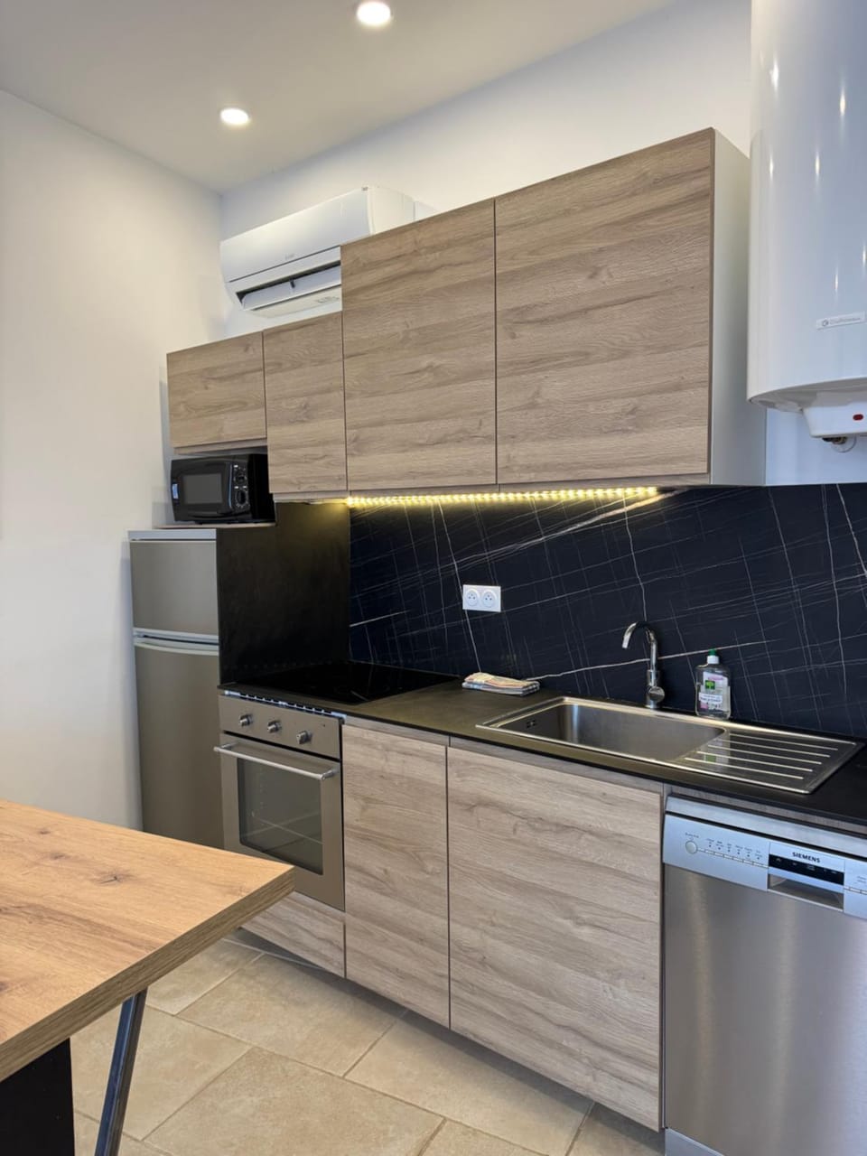 Kitchen or kitchenette, dishwasher, oven, stove