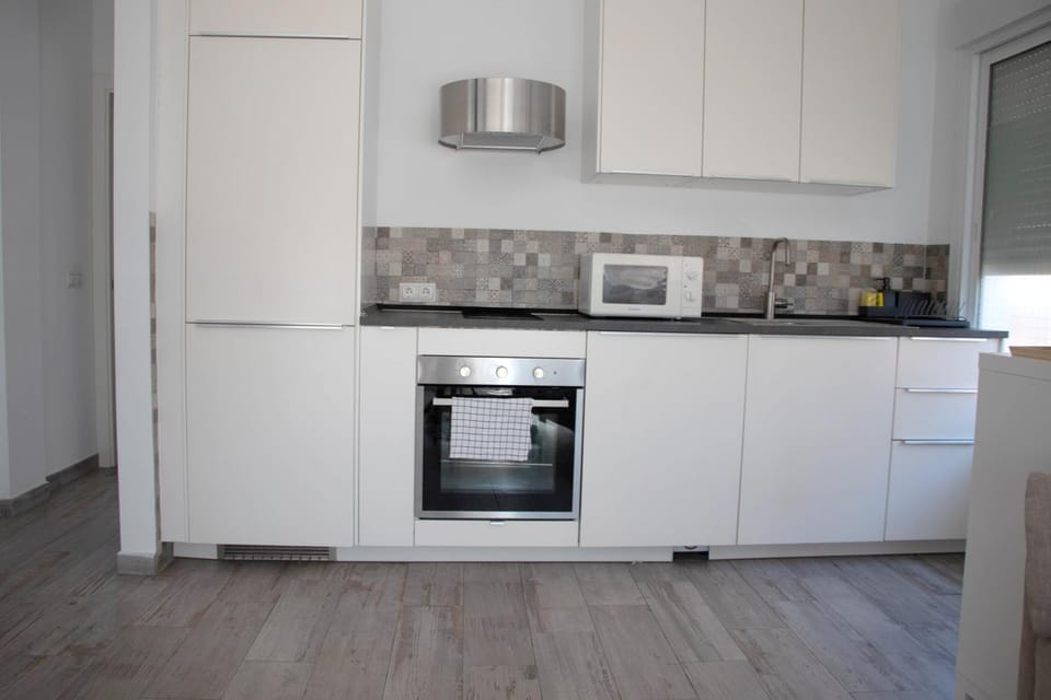 Kitchen or kitchenette, microwave, oven, stove, washing machine