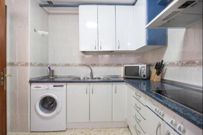 Kitchen or kitchenette, microwave, stove, washing machine