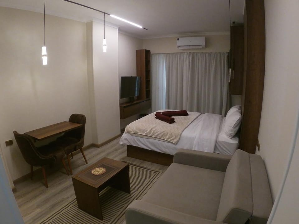 Bed, TV and multimedia, Living room, Photo of the whole room, Seating area, Dining area, Bedroom, hair dryier, wardrobe, air conditioner