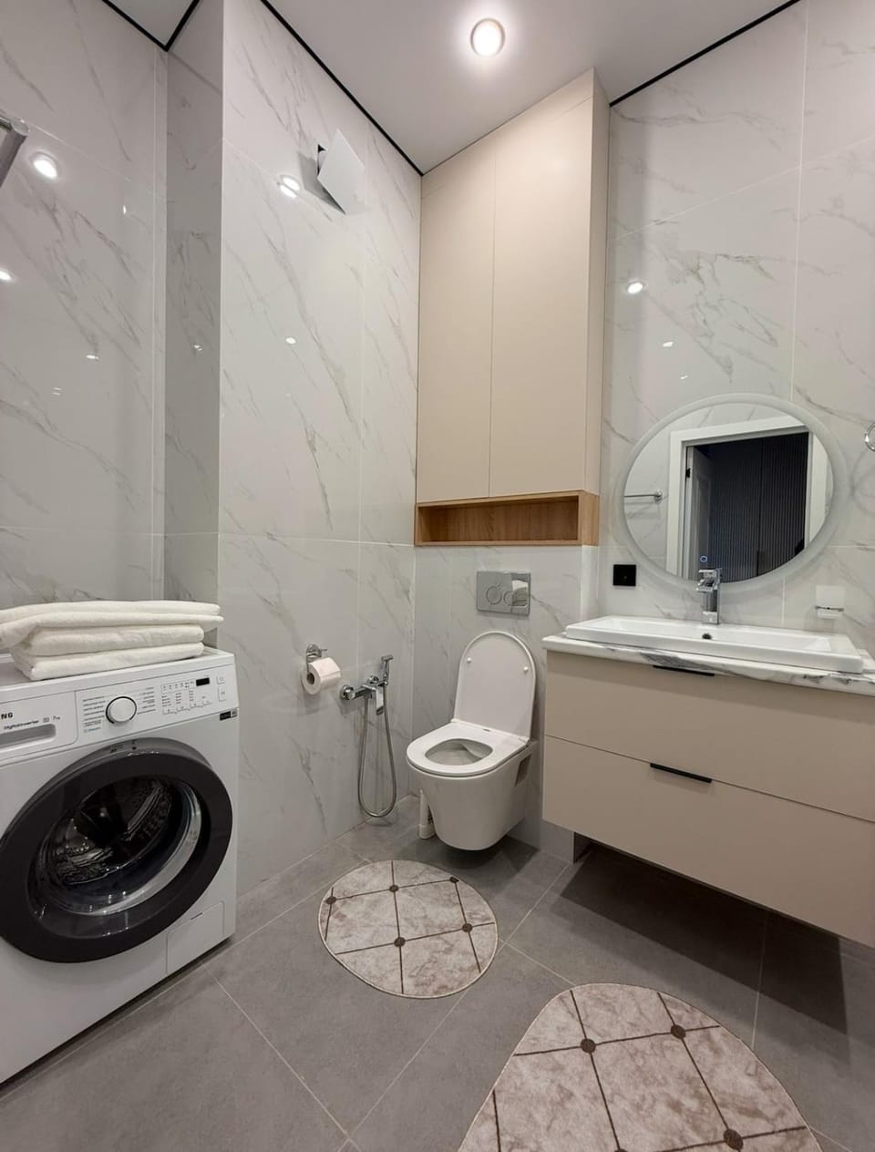 Toilet, towels, washing machine
