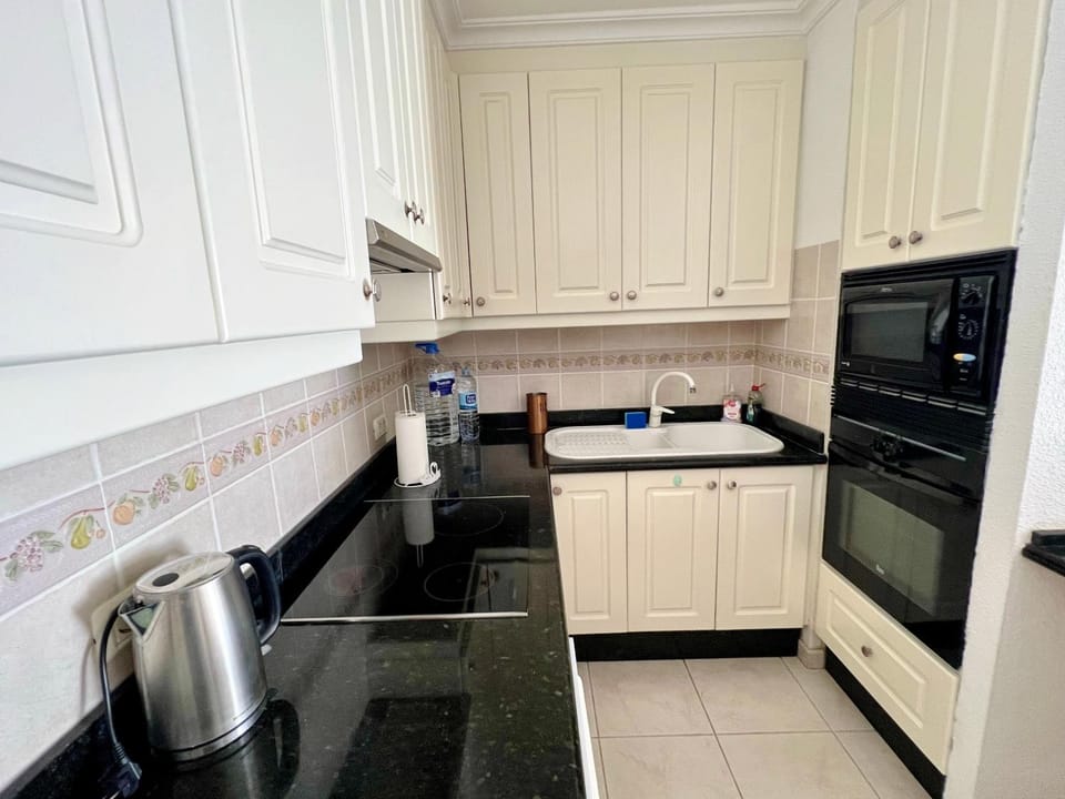 Kitchen or kitchenette, microwave, oven, stove
