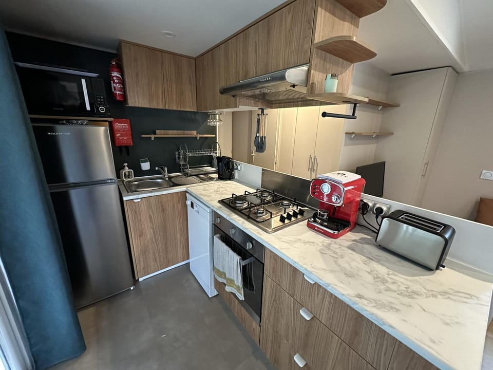 Kitchen or kitchenette, dishwasher, oven, stove, toaster