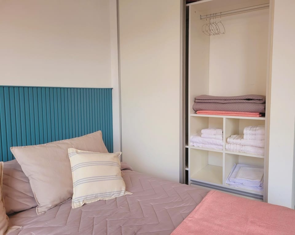Bed, towels, wardrobe