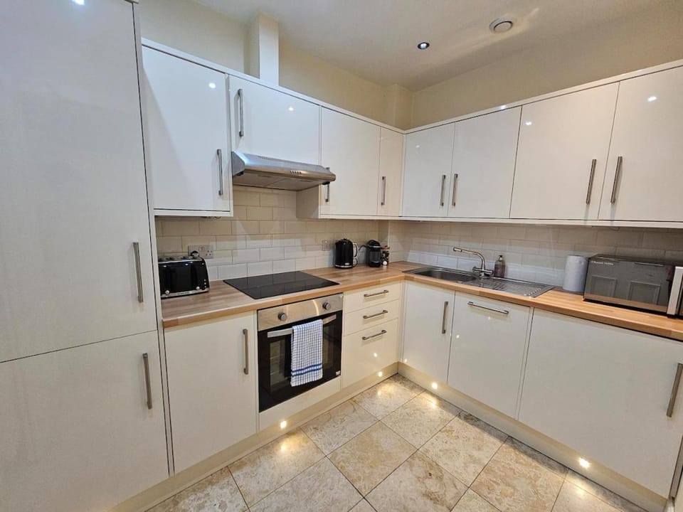 Kitchen or kitchenette, dishwasher, oven, stove, toaster