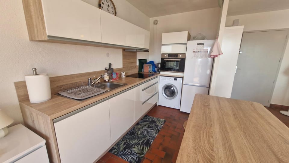 Kitchen or kitchenette, dishwasher, oven, stove, toaster, washing machine