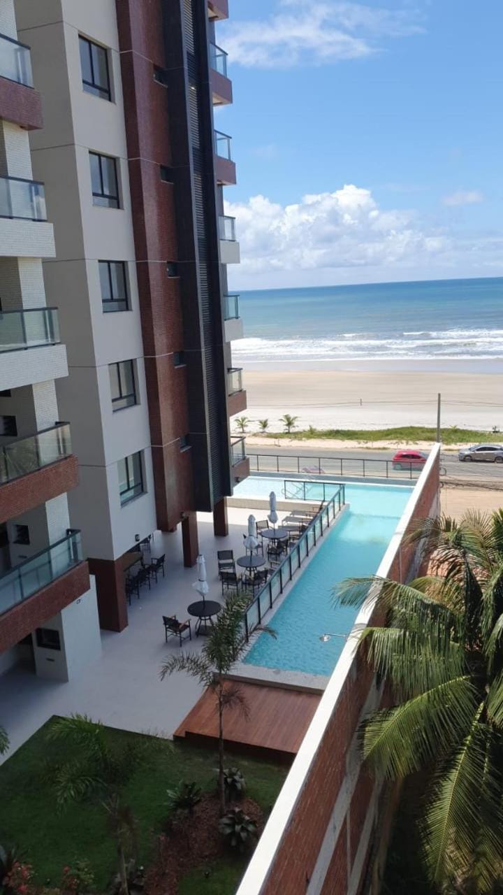Property building, Patio, Day, Natural landscape, View (from property/room), Beach, Pool view, Sea view, Swimming pool, sunbed