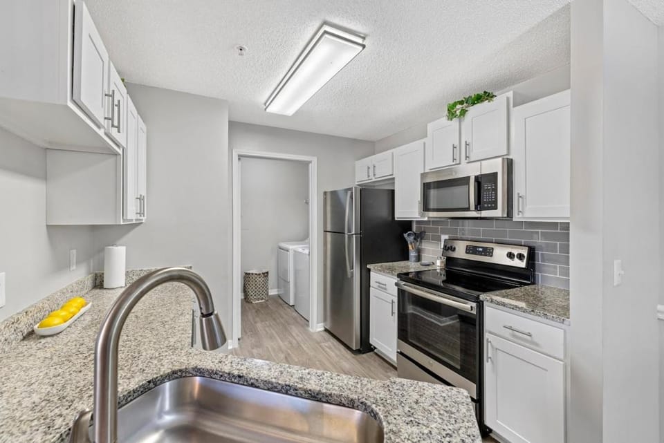 Kitchen or kitchenette, dishwasher, oven, stove