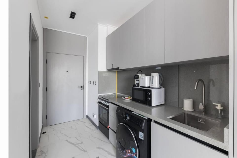 Kitchen or kitchenette, microwave, stove, toaster, washing machine